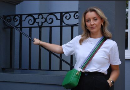 white tshirt, black trousers, blonde her, green and tan animal print bag strap, green bag, leather bag, crossbody bag