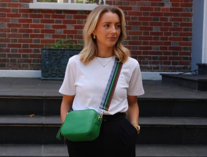 white tshirt, black trousers, blonde her, green and tan animal print bag strap, green bag, leather bag, crossbody bag