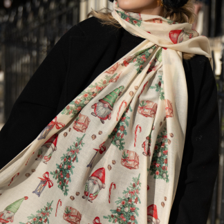 Blonde lady standing outside white buildings in chelsea, wearing an all back outfit, taupe jumper and a hand printed gonks design scarf with black sunglasses on